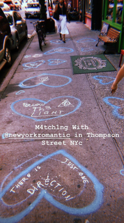 a picture of matching art work from two different artists on Thompson Street in Greenwich Village
