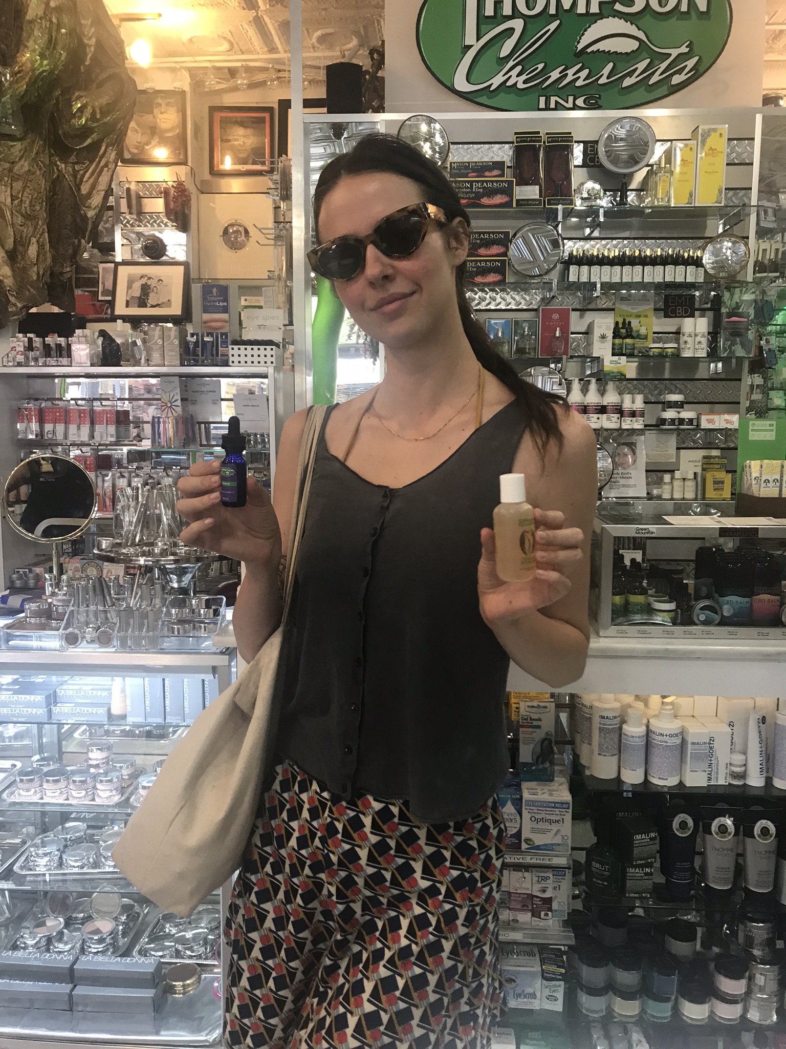 Pretty lady holding Thompson Alchemists body products