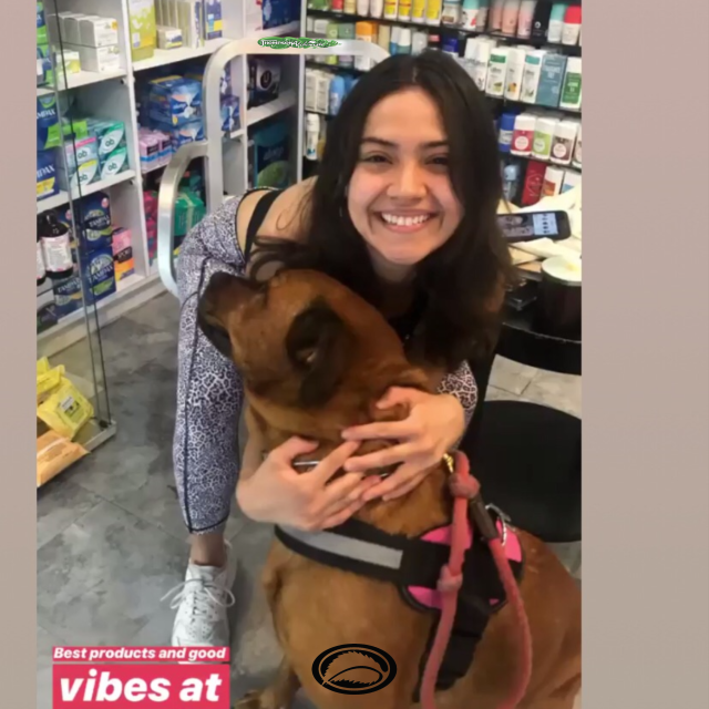 pamela hugging rego barks the Thompson Alchemists mascot