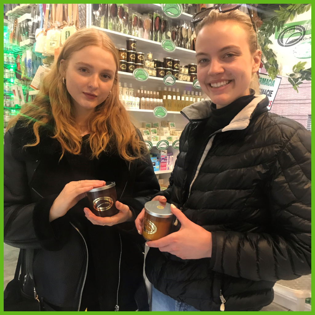 a picture of two girls holding candles inside Thompson Alchemists