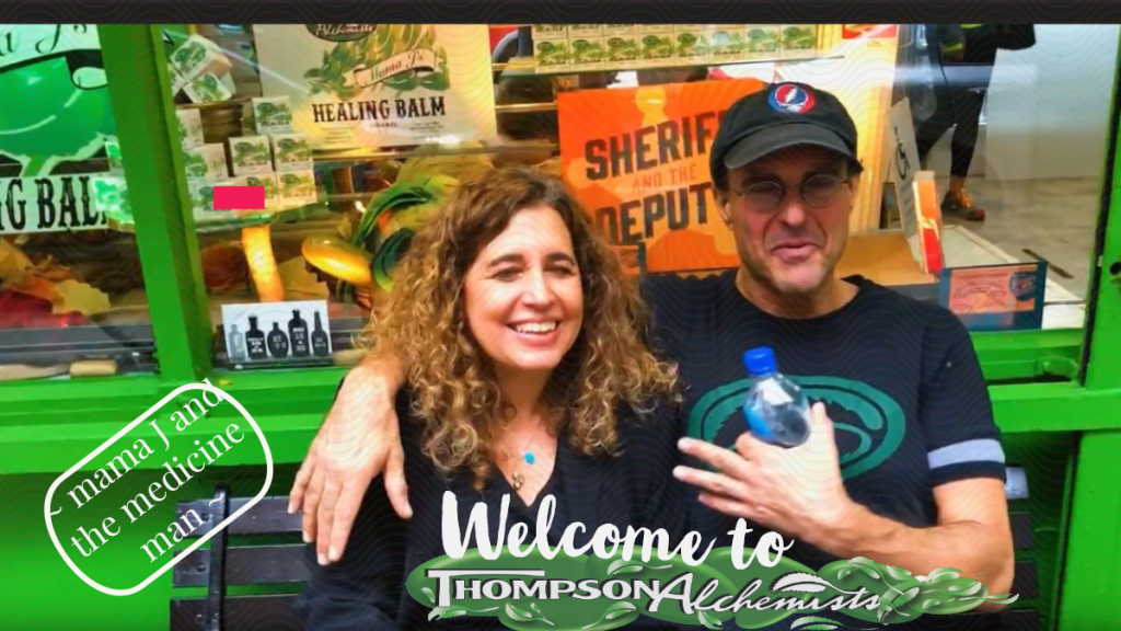 mama j and the medicine man owner of Thompson Chemists, Thompson Alchemists in front of soho nyc shop in a grateful dead cap and healing balm all around.